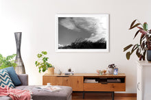 Load image into Gallery viewer, Near Pyramid Rock, Phillip Island. Lone seabird flying into a strong south wind (kareela). This black and white image is framed in a white frame.
